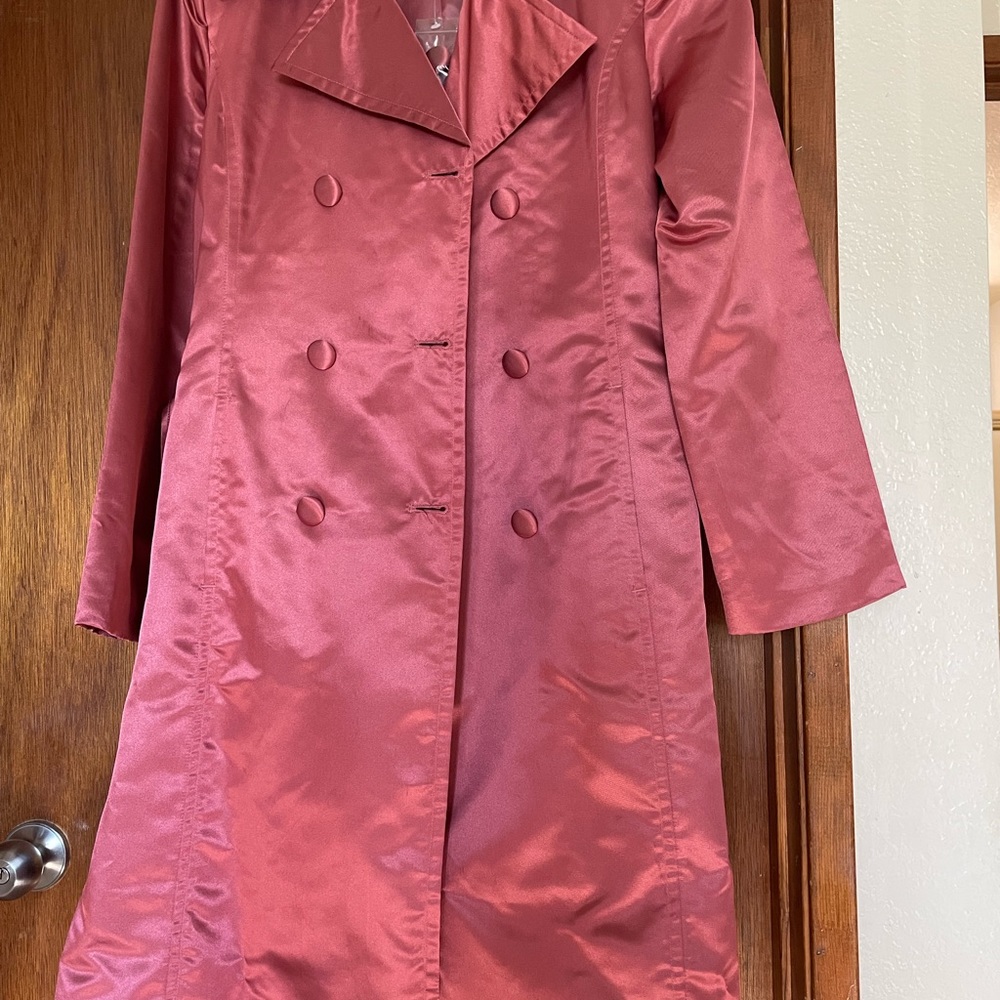 Light Pink Spiegel coat with a tie in the middle. Outside is shiny, inside lined